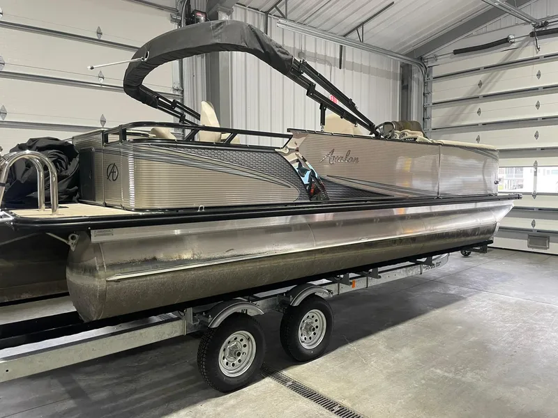 Slide: The Image of 2019 Avalon Lsz Rear Fish 24' pontoon boat on trailer in garage. - 3