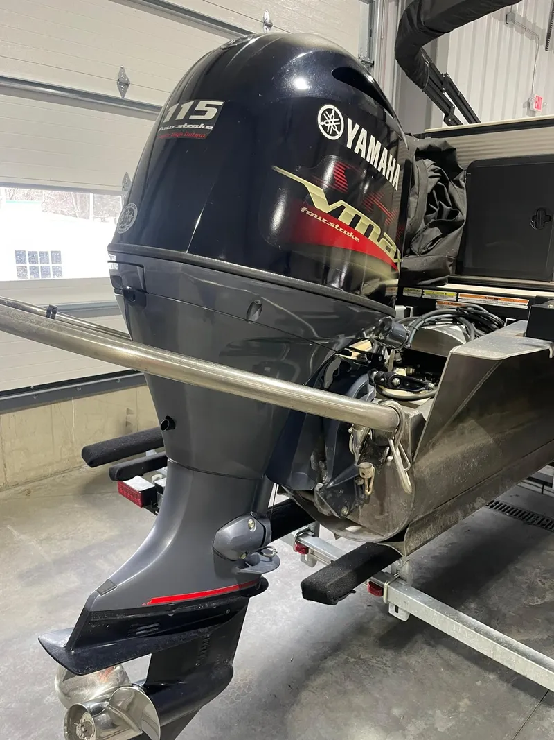 Slide: The Image of 2019 Avalon Lsz Rear Fish 24' with Yamaha 115 outboard motor in garage. - 4