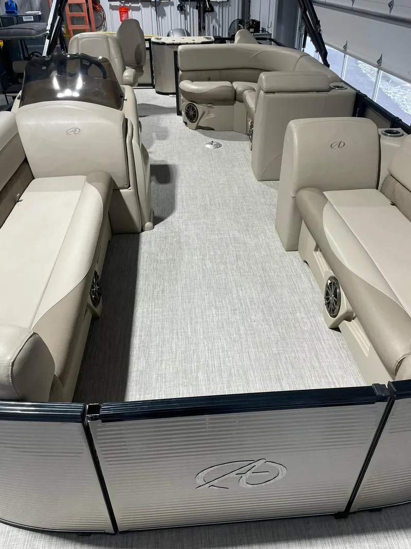 Slide: The Image of 2019 Avalon Lsz Rear Fish 24' pontoon boat interior with beige seating and spacious layout. - 6