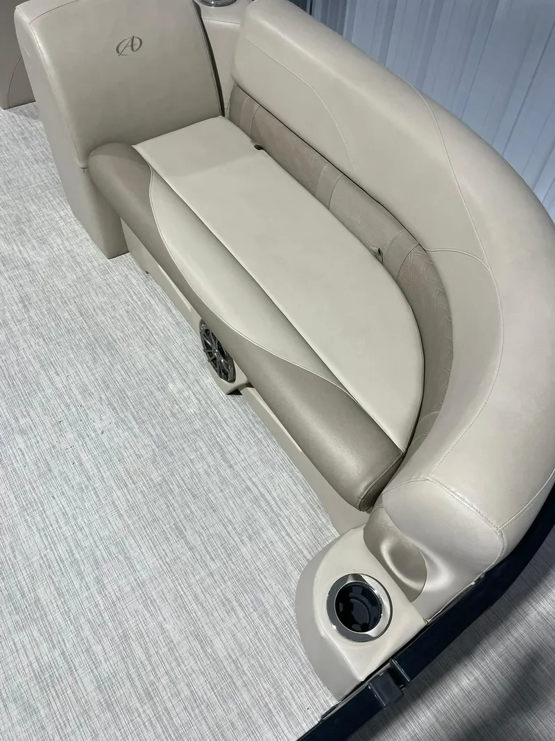 Slide: The Image of 2019 Avalon Lsz Rear Fish 24' boat interior with beige seating and cup holders. - 7