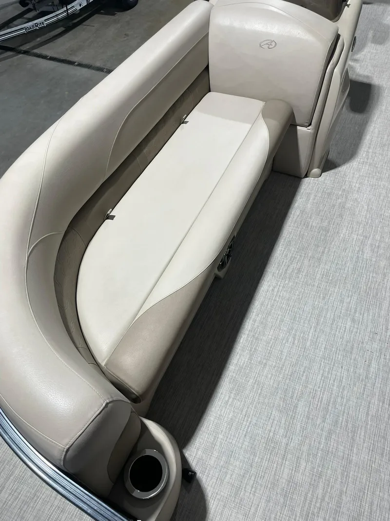 Slide: The Image of 2019 Avalon Lsz Rear Fish 24' boat interior with beige seating and cup holder. - 8