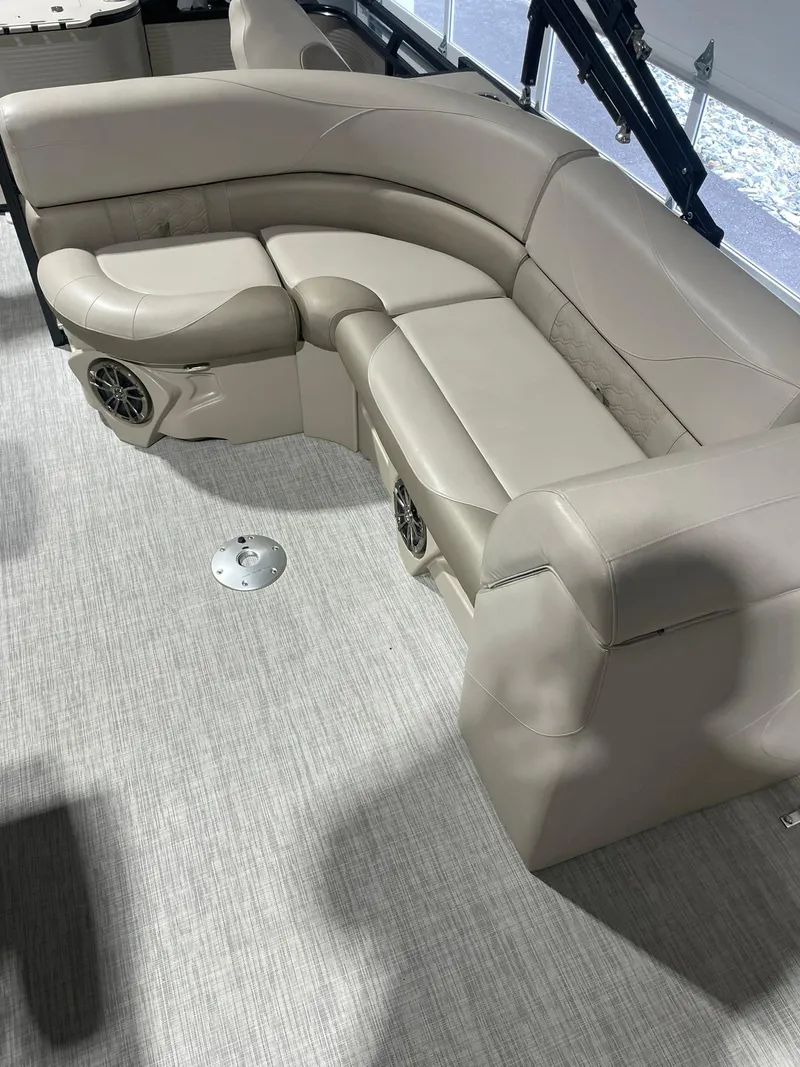 Slide: The Image of 2019 Avalon Lsz Rear Fish 24' boat interior with beige seating and speaker system. - 9