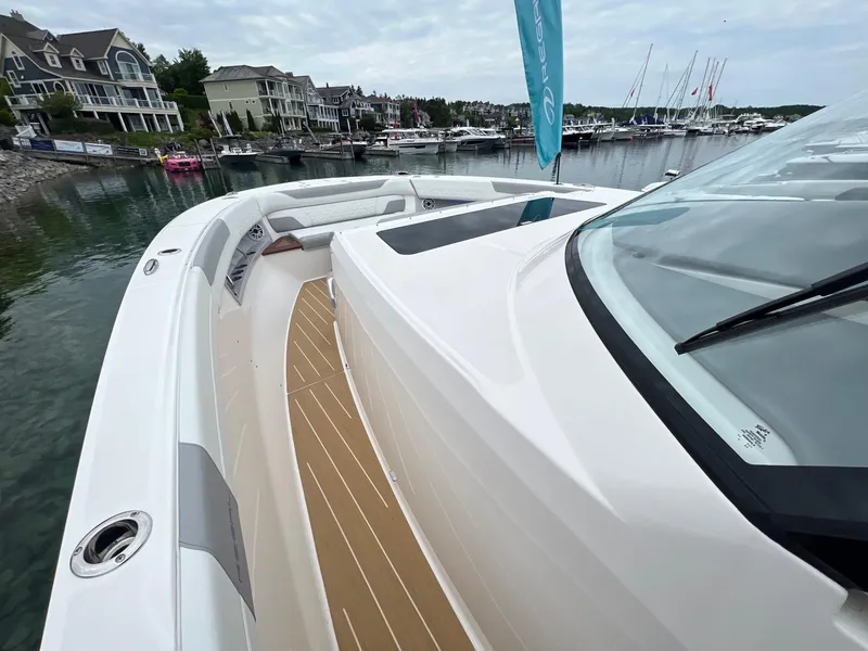 Slide: The Image of 2026 Regal 50 SAV yacht docked in a marina, showcasing sleek design and spacious deck. - 18
