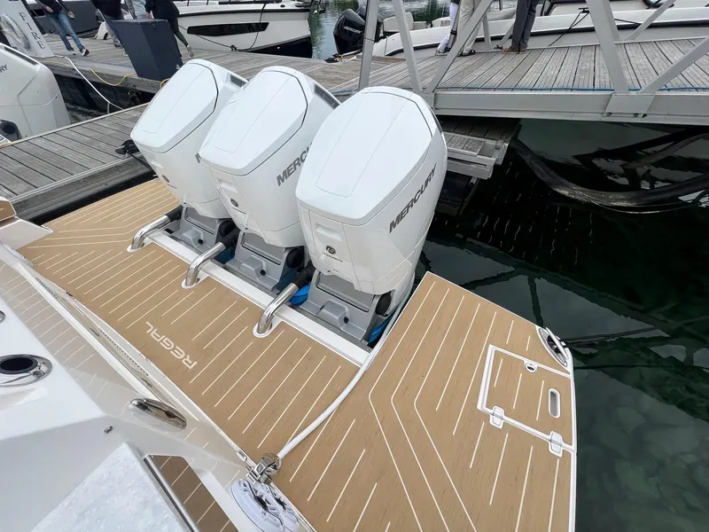 Slide: The Image of 2026 Regal 50 SAV boat with triple Mercury outboard engines at dock. - 3