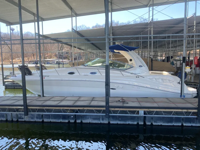 The Image of 2003 Sea Ray 340 Sundancer docked in a covered marina, side view. - 0