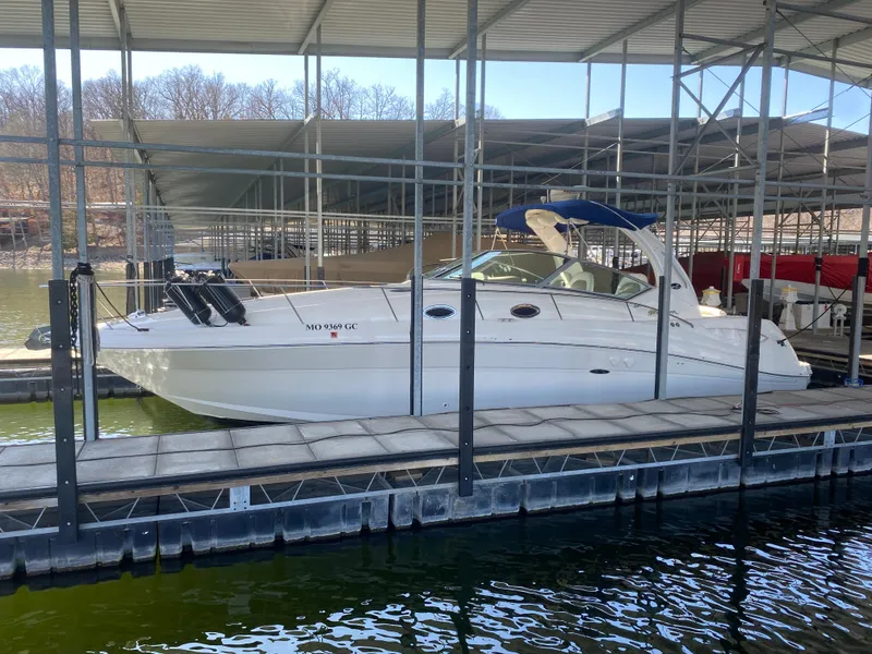 Slide: The Image of 2003 Sea Ray 340 Sundancer docked in a covered marina. - 1