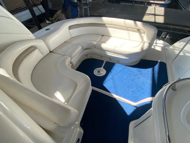 Slide: The Image of 2003 Sea Ray 340 Sundancer interior with white seating and blue carpet. - 11