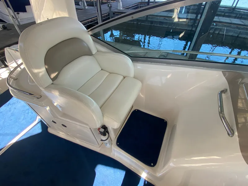 Slide: The Image of Captain's seat on 2003 Sea Ray 340 Sundancer yacht, featuring white upholstery and blue accents. - 12