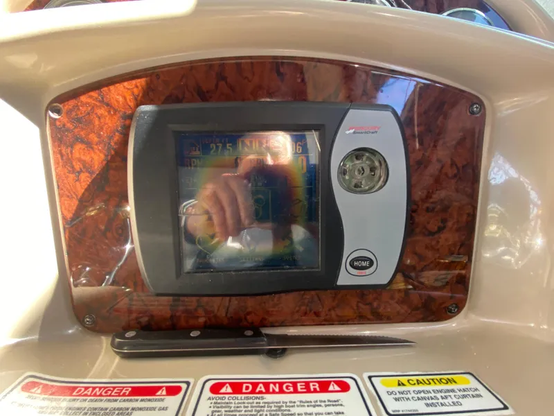 Slide: The Image of Dashboard of 2003 Sea Ray 340 Sundancer with navigation display and warning labels. - 16