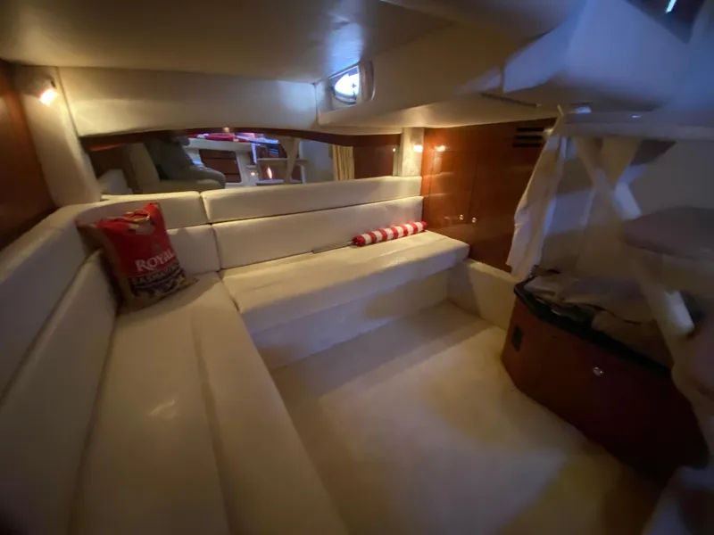 Slide: The Image of Interior of 2003 Sea Ray 340 Sundancer yacht with cozy seating and ambient lighting. - 28