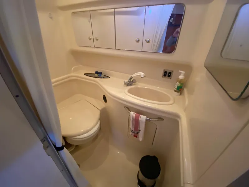 Slide: The Image of 2003 Sea Ray 340 Sundancer bathroom with sink, toilet, and mirror cabinet. - 30