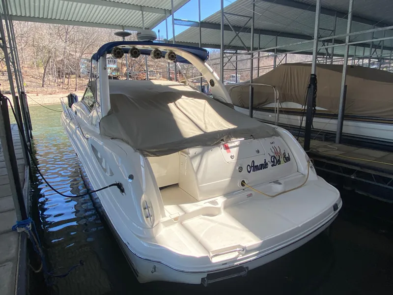 Slide: The Image of 2003 Sea Ray 340 Sundancer docked under a covered marina. - 37