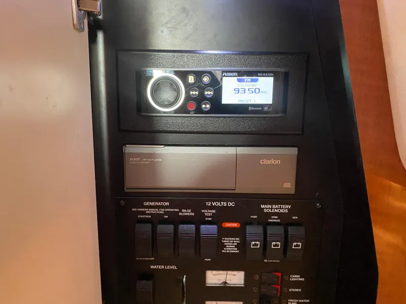 Slide: The Image of Control panel of a 2003 Sea Ray 340 Sundancer boat with radio and switches. - 39