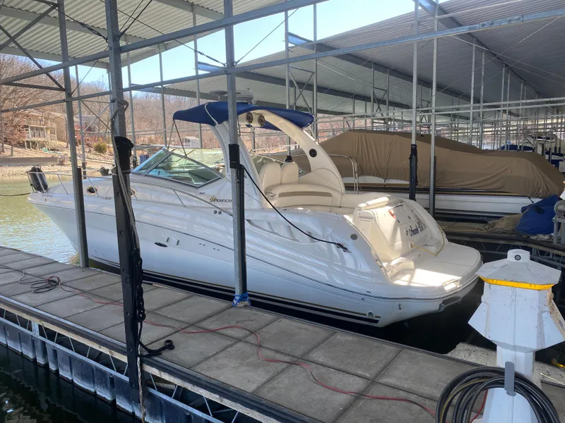 Slide: The Image of 2003 Sea Ray 340 Sundancer docked in a marina under a covered structure. - 42