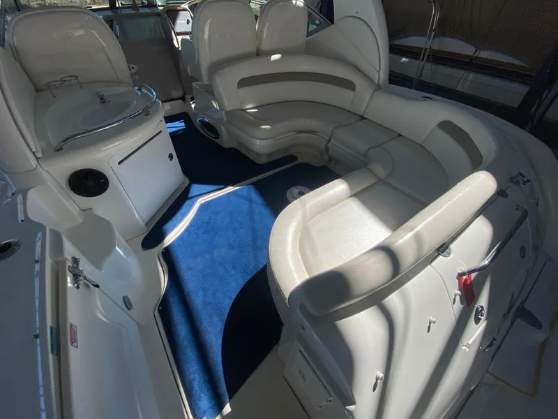 Slide: The Image of 2003 Sea Ray 340 Sundancer interior with curved seating and blue carpet. - 7