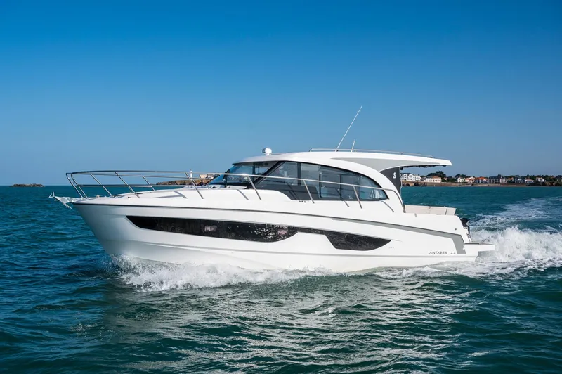 Slide: The Image of 2026 Beneteau Antares 11 OB cruising on open water under clear blue skies. - 2