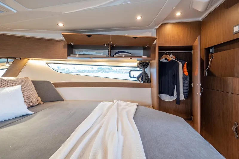 Slide: The Image of Luxurious cabin interior of 2026 Beneteau Antares 11 OB with cozy bedding and storage. - 28