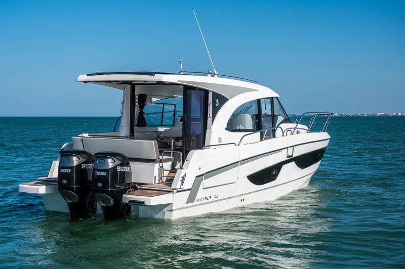 Slide: The Image of 2026 Beneteau Antares 11 OB cruising on open water, featuring dual Suzuki outboard engines. - 6