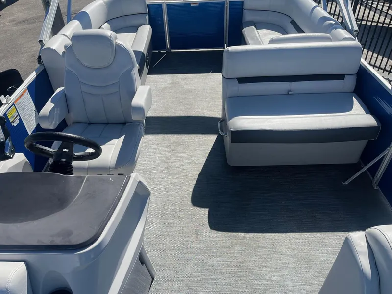 Slide: The Image of 2022 Godfrey SWEETWATER 2286 SFL pontoon boat interior with plush seating and steering console. - 12