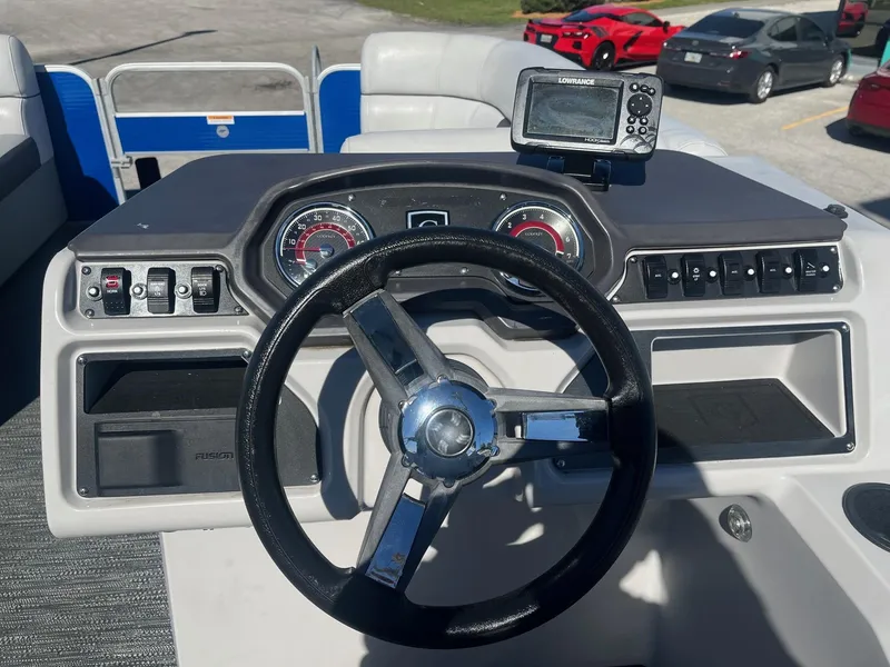 Slide: The Image of 2022 Godfrey SWEETWATER 2286 SFL boat dashboard with steering wheel and navigation system. - 6