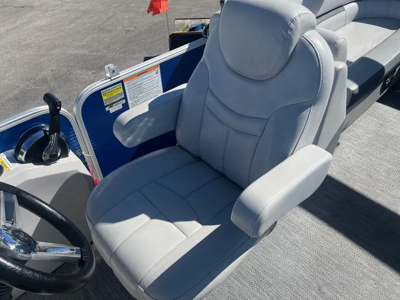 Slide: The Image of Captain's chair on 2022 Godfrey SWEETWATER 2286 SFL pontoon boat, featuring plush gray upholstery. - 7