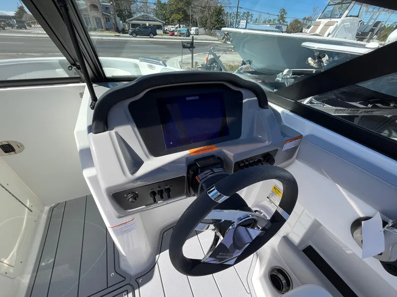 Slide: The Image of 2025 Chaparral 21 SSi OB boat dashboard with steering wheel and control panel. - 10