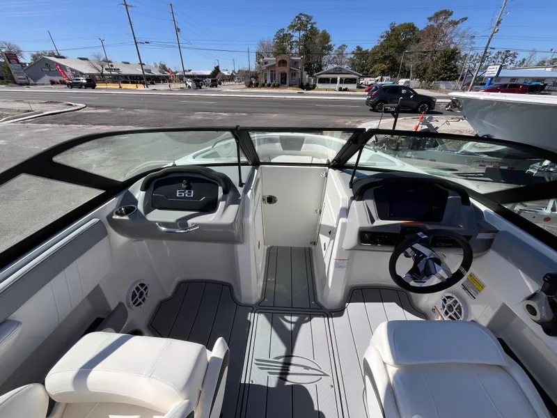 Slide: The Image of 2025 Chaparral 21 SSi OB boat interior with modern dashboard and seating. - 11