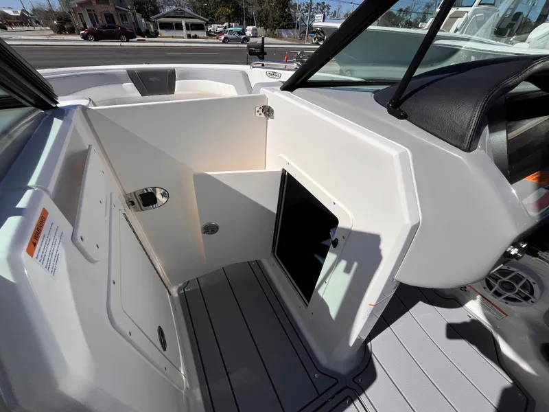 Slide: The Image of 2025 Chaparral 21 SSi OB boat interior, featuring storage compartment and sleek design. - 16