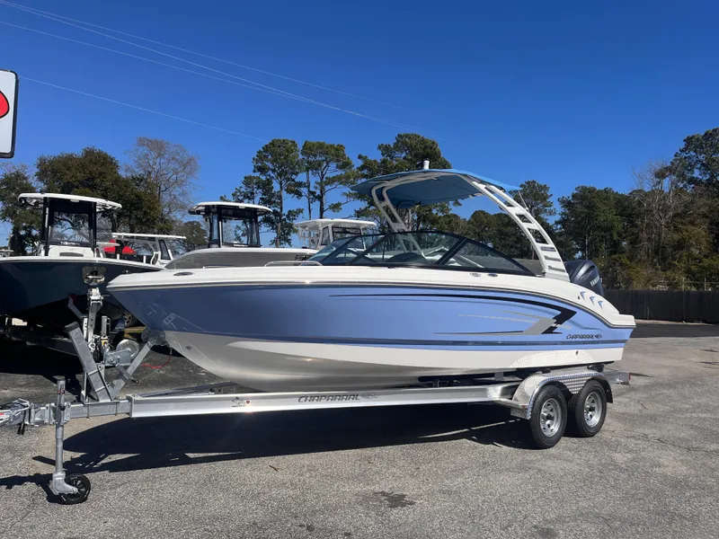 Slide: The Image of 2025 Chaparral 21 SSi OB boat on trailer, parked outdoors. - 2