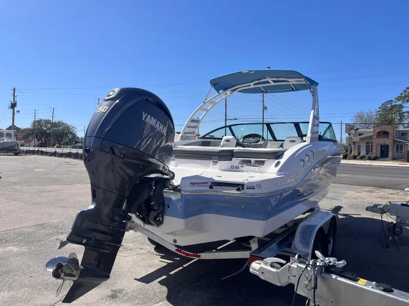 Slide: The Image of 2025 Chaparral 21 SSi OB boat with Yamaha outboard motor in a sunny parking lot. - 5