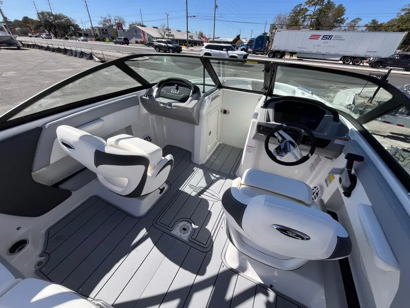 Slide: The Image of 2025 Chaparral 21 SSi OB boat interior with modern seating and steering wheel. - 9