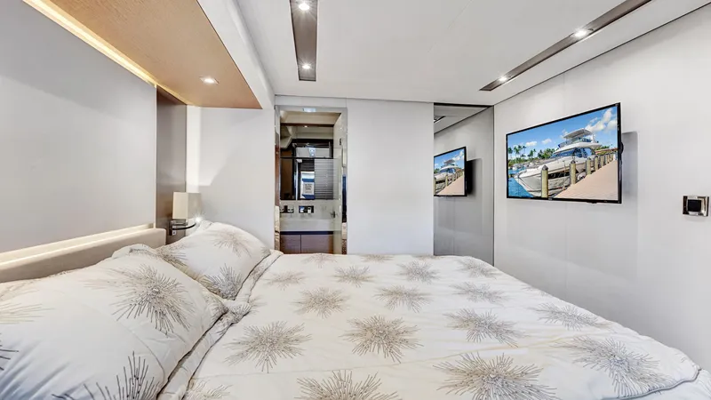 Slide: The Image of Luxurious bedroom interior on a 2018 Prestige 680 yacht, featuring modern design and TV. - 12