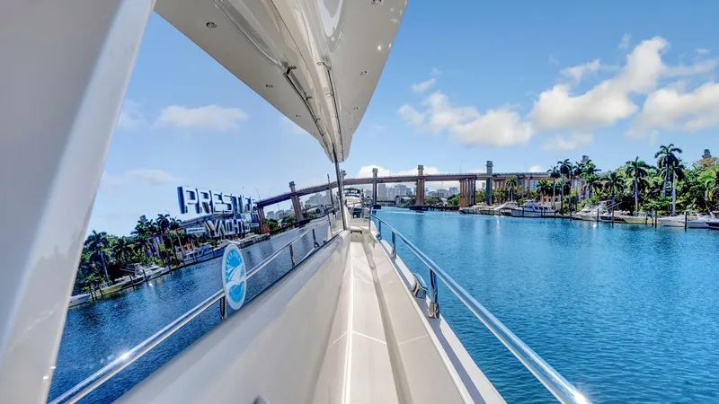 Slide: The Image of 2018 Prestige 680 yacht cruising on a scenic waterway with clear skies. - 19