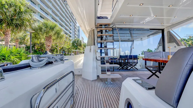 Slide: The Image of Luxurious 2018 Prestige 680 yacht deck with modern seating and spiral staircase. - 25