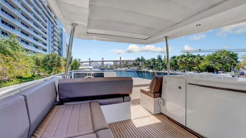 Slide: The Image of Luxurious 2018 Prestige 680 yacht deck with seating, overlooking waterfront and cityscape. - 27