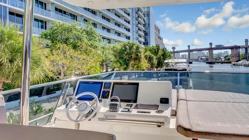 Slide: The Image of Prestige 680 yacht helm with cityscape and waterway view, 2018 model. - 28