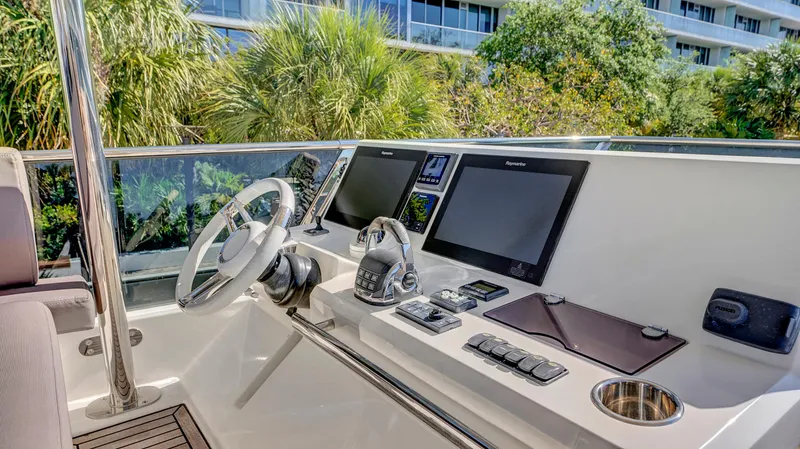 Slide: The Image of Helm of 2018 Prestige 680 yacht with modern navigation equipment and controls. - 29