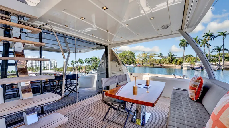 Slide: The Image of Luxurious 2018 Prestige 680 yacht interior with elegant seating and scenic waterfront view. - 3