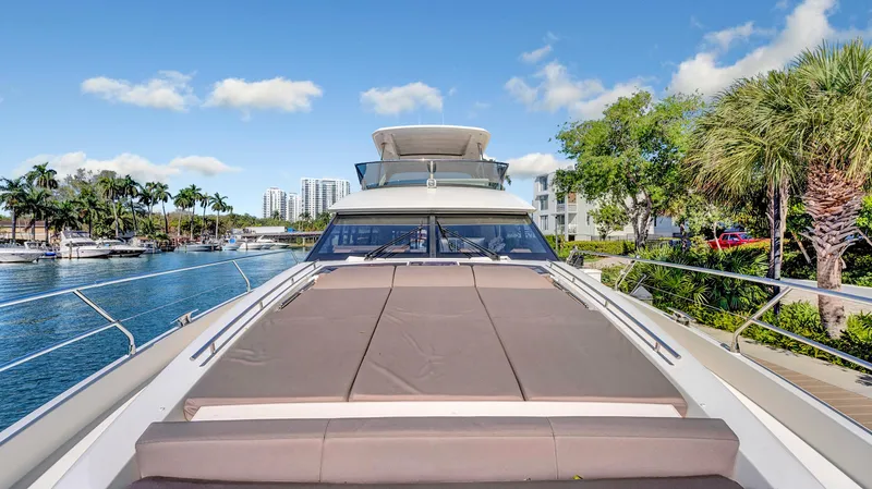 Slide: The Image of Luxury 2018 Prestige 680 yacht docked by palm trees and waterfront buildings. - 31