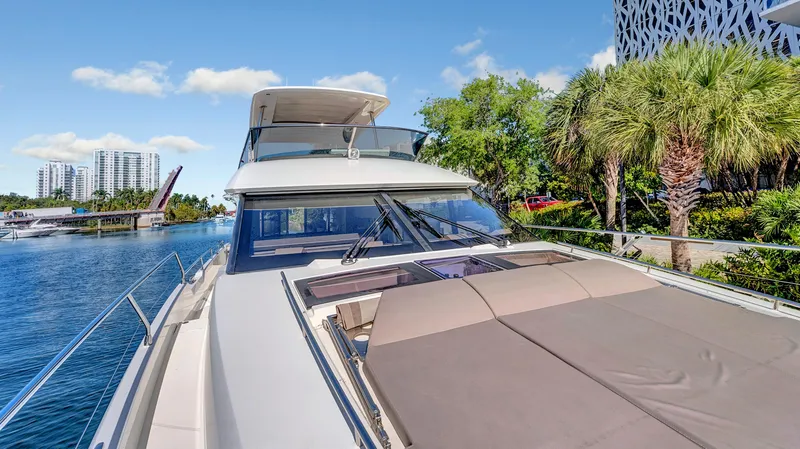 Slide: The Image of Luxurious 2018 Prestige 680 yacht docked by palm trees and modern buildings. - 32