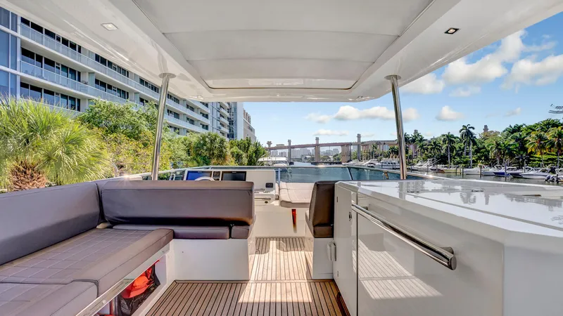 Slide: The Image of Luxurious 2018 Prestige 680 yacht deck with seating, docked near waterfront buildings. - 4