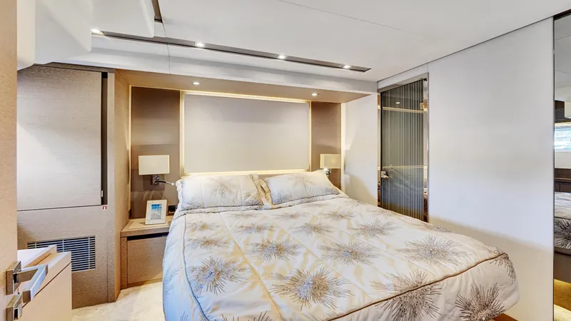 Slide: The Image of Luxurious bedroom interior on a 2018 Prestige 680 yacht, featuring elegant bedding and modern lighting. - 49