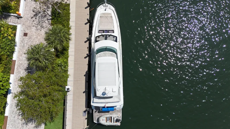Slide: The Image of Aerial view of 2018 Prestige 680 yacht docked by a lush, green shoreline. - 6