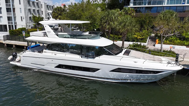 Slide: The Image of Luxury 2018 Prestige 680 yacht docked by waterfront buildings. - 7