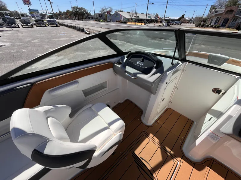 Slide: The Image of Interior view of 2025 Chaparral 23 SSi OB boat, featuring sleek seating and modern dashboard. - 11