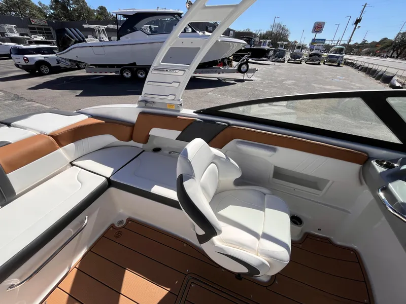 Slide: The Image of 2025 Chaparral 23 SSi OB boat interior with white seating and brown accents. - 8
