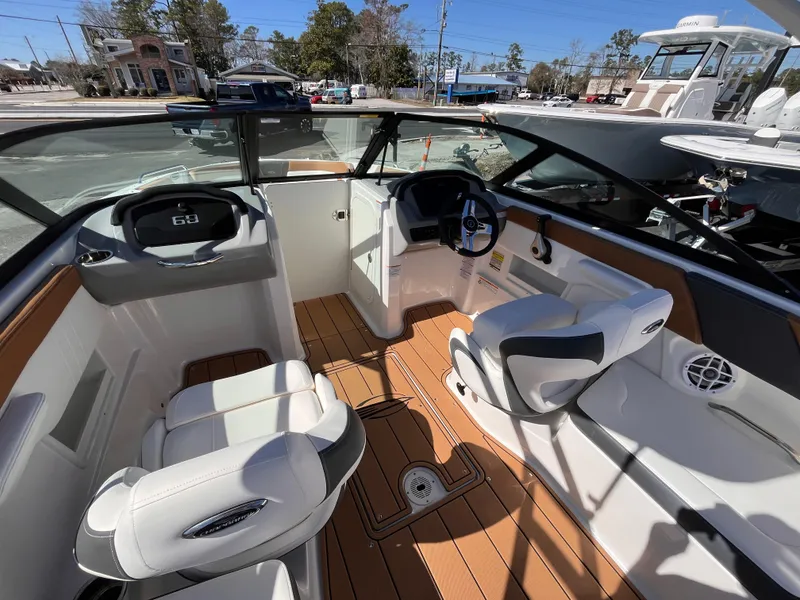 Slide: The Image of 2025 Chaparral 23 SSi OB boat interior with modern seating and steering wheel. - 9