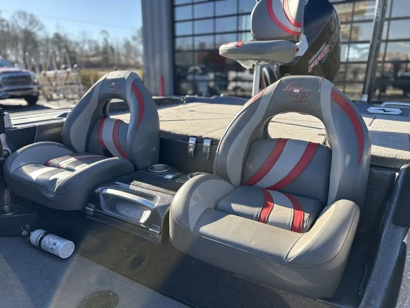 Slide: The Image of 2022 Bass Cat Cougar FTD boat seats with red accents, outdoor setting. - 15