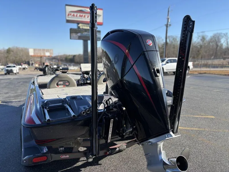 Slide: The Image of 2022 Bass Cat Cougar FTD boat with powerful outboard motor in parking lot. - 19