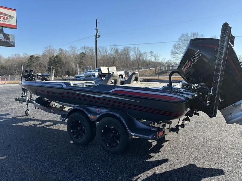 Slide: The Image of 2022 Bass Cat Cougar FTD boat on trailer, parked outdoors on a sunny day. - 3